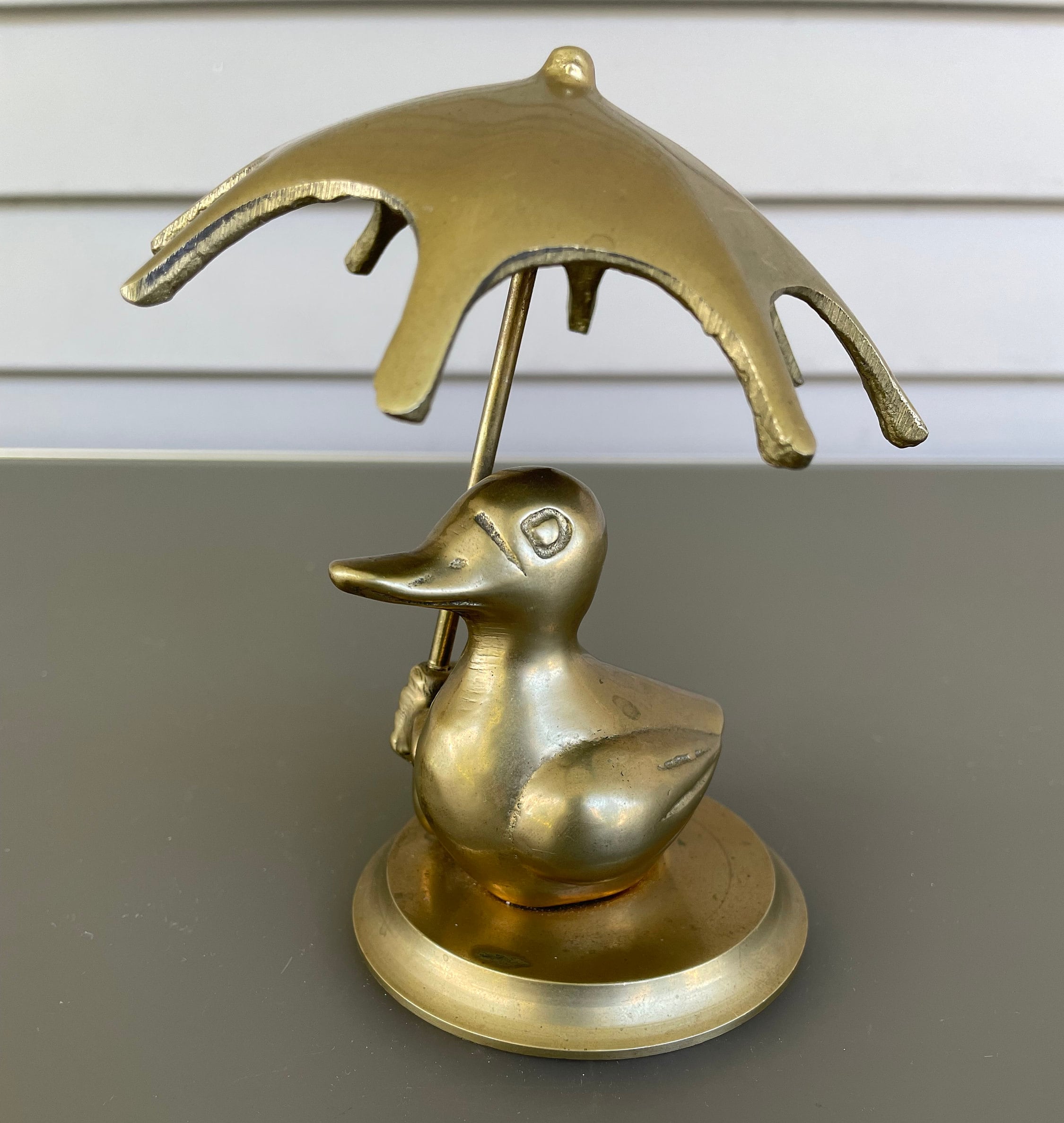 brass duck with umbrella