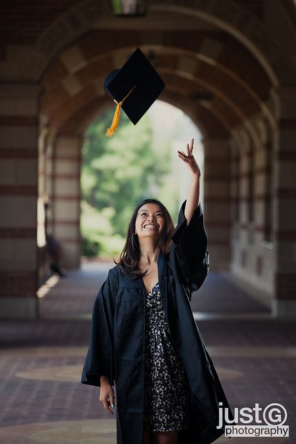 poses for graduation photos