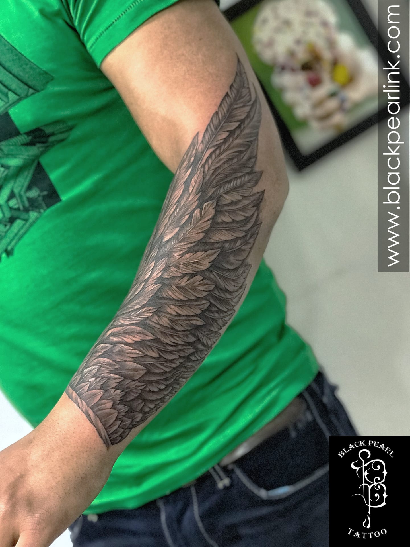 wings on forearm tattoo