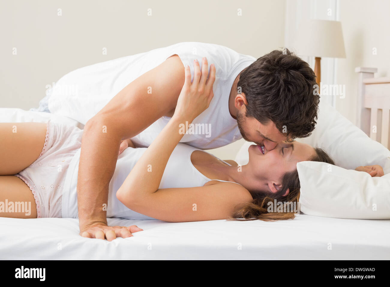 couple kissing in bed